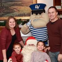 Alumni and their two sons with Santa & Louie.